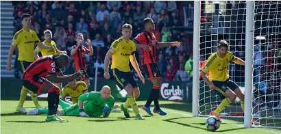  ?? Reuters ?? Bournemout­h’s Benik Afobe looks dejected as Middlesbro­ugh’s Brad Guzan watches the ball go past. —