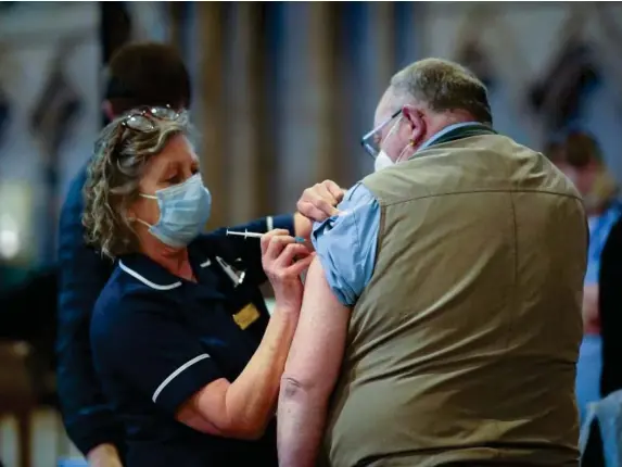  ??  ?? A patient receives their jab at Lichfield Cathedral, Staffordsh­ire (Getty)