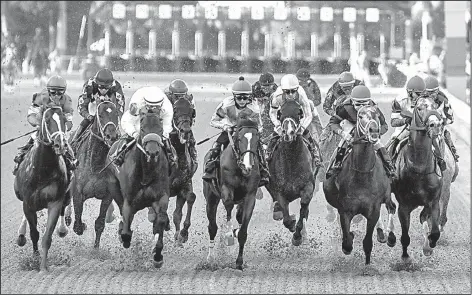  ?? Arkansas Democrat-Gazette/MITCHELL PE MASILUN ?? Horses head to the first turn during Saturday’s Arkansas Derby at Oaklawn Park in Hot Springs. Classic Empire, ridden by Julien Leparoux, won the race in 1:48.93. Conquest Mo Money was second, while Lookin At Lee was third. With the victory, Classic...