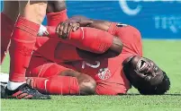  ?? FREDERIC J. BROWN AFP/GETTY IMAGES ?? Canada midfielder Alphonso Davies took a boot to the ankle early, but played until the 69th minute on Saturday.