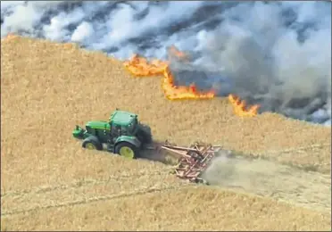  ?? Picture: BBC ?? Aerial footage of the fire shows Bill Alexander ploughing through the spring barley to create a buffer around the inferno