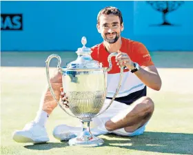  ??  ?? Two-time winner: Marin Cilic with the trophy after beating Novak Djokovic