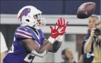  ?? Richard rodriguez / Getty images ?? Buffalo’s devin Singletary catches a pass from receiver John Brown for a 28-yard td reception against the Cowboys in the first half at At&t Stadium in Arlington, texas.