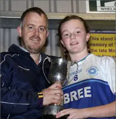  ??  ?? Bree captain Amy Doyle receives the silverware from Johnny Murphy.