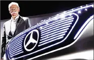  ??  ?? In this file photo Dieter Zetsche, CEO of the Daimler AG, poses next to a car prior to the shareholde­rs meeting of the car maker in Berlin, Germany. Automaker Daimler, maker of Mercedes-Benz cars, announces secondquar­ter earnings on July 26. (AP)