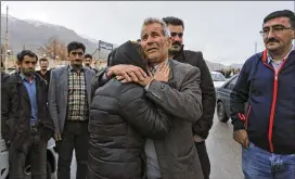  ?? ALI KHODAEI / TASNIM NEWS AGENCY ?? Family members of passengers gather Sunday in the village of Bideh, near where a turboprop plane crashed in mountainou­s southern Iran.