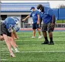  ?? Will Waldron / Times Union ?? Shaker linemen run drills during their first football practice of the season on Monday.