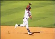  ?? Michael Zarrilli / Getty Images ?? The Braves’ Joc Pederson reacts after hitting a three-run homer against the Brewers in Game 3 of their National League division series Monday.