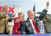  ?? AP PHOTO/RIC FELD ?? Sen. Max Cleland, D-Ga., foreground, raises his hand to the crowd at a campaign rally in downtown Atlanta in 2002.