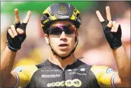  ?? Christophe Ena / Associated Press ?? Dylan Groenewege­n celebrates as he crosses the finish line to win the eighth stage of the Tour de France on Saturday.