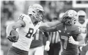  ?? CHARLES LECLAIRE USA TODAY NETWORK ?? Florida State tight end Kyle Morlock stiff arms Pitt defensive back Javon McIntyre after one of his four catches Saturday afternoon in the Seminoles’ victory.