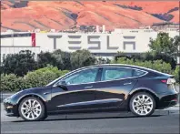  ?? COURTESY OF TESLA MOTORS VIA AP ?? This undated image provided by Tesla Motors shows the Tesla Model 3 sedan. The electric car company’s newest vehicle, the Model 3, is half the cost of previous models.