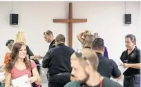  ??  ?? Luis Garcia, right, hands out packs of Narcan during a training class at Saint Philip Lutheran Church.