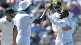  ??  ?? MODEST MAN: Temba Bavuma celebrates with Faf du Plessis and Vernon Philander after his sensationa­l run out at the Waca.