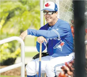  ?? NATHAN DENETTE / THE CANADIAN PRESS ?? Toronto Blue Jays manager Charlie Montoyo watches from the bleachers Tuesday as his players participat­e in spring training drills at Dunedin, Fla.