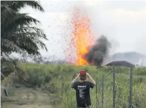  ?? Photo: AFP ?? A man takes a photo of a lava fountain from a Kilauea volcano fissure on Hawaii’s Big Island.