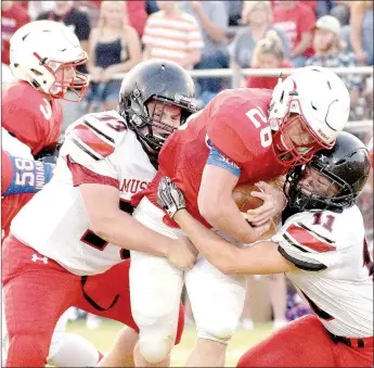  ?? RICK PECK/MCDONALD COUNTY PRESS ?? McDonald County’s David Roark (11) and Nolan Baisch (73) team up to stop Seneca’s Trey Wilson during the Indians’ 41-13 win on Sept. 1 at Seneca High School.