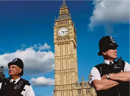  ?? AFP PIC ?? Police officers standing guard outside the Houses of Parliament, beneath the Big Ben, in Westminste­r, London. Brexit is a tumultuous event in the history of Britain and the European Union.