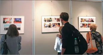  ?? PENG DAWEI / CHINA NEWS SERVICE ?? Visitors look at photos of an exhibition featuring China’s Belt and Road Initiative at the Chinese Culture Center in Berlin.