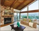  ??  ?? The family room features a massive stone fireplace and views.