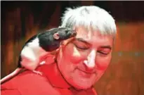  ??  ?? Charlotte the rat leans against Garth Honhart's face during a popup Rat Cafe at the San Francisco Dungeon in San Francisco, California.