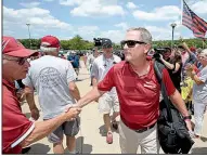  ??  ?? NWA Democrat-Gazette/ANDY SHUPEArkan­sas Coach Dave Van Horn greets fans Friday at Baum Stadium. “It was a season of high expectatio­ns and we ended up finishing No. 2 in the country,” he said.