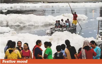  ?? AFP ?? A family rides on a boat on their way to immerse a statue of the Hindu deity Ganesh in the Yamuna river, during the 11-day long festival of Ganesh Chaturthi in New Delhi. The festival, which is annually celebrated across the country, runs this year from September 13 to September 23, and culminates with the immersion of statues in local water bodies.