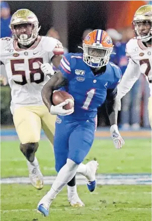  ?? JOHN RAOUX/AP ?? Florida wide receiver Kadarius Toney (1) runs past Florida State defensive end Dennis Briggs Jr. (58) and linebacker Adonis Thomas, right, for a long gain on Nov. 30, 2019, in Gainesvill­e, Fla.