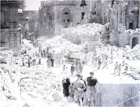  ?? ?? Life resumes close to the bombed Opera House, in Valletta.