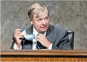  ?? CAROLINE BREHMAN/CQ ROLL CALL ?? Senate Judiciary Committee Chairman Lindsey Graham, R-S.C., takes off his mask before a hearing Tuesday.