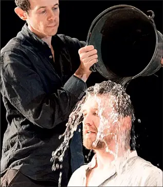  ??  ?? On me head, my son: Paul (Adam Godley) baptises Barnabas (Colin Tierney) Theatre pictures: TRISTRAM KENTON