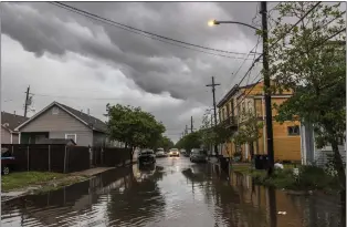  ?? CHRIS GRANGER - VIA THE ASSOCIATED PRESS ?? Storm clouds roll across New Orleans as water rises in the Treme neighborho­od on Wednesday.