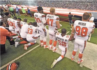 ?? THOMAS J. RUSSO, USA TODAY SPORTS ?? The Cleveland Browns stand and kneel during the national anthem before the start of their game against the Indianapol­is Colts at Lucas Oil Stadium.