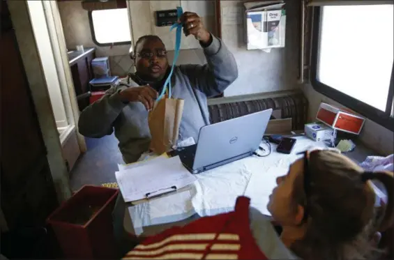  ??  ?? Darryl Mack, a health educator with the Baltimore City Health Department, places tourniquet­s into a bag containing clean needles for a client inside the health department’s Needle Exchange Team van in Baltimore. An overdose-reversal drug is a critical...