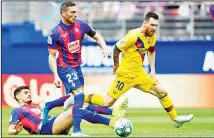  ??  ?? Barcelona’s Lionel Messi (right), is tackled by Eibar’s Sergio Alvarez (left), during a Spanish La Liga soccer match between Eibar and FC Barcelona
at the Ipurua Stadium in Eibar, Spain on Oct 19. (AP)