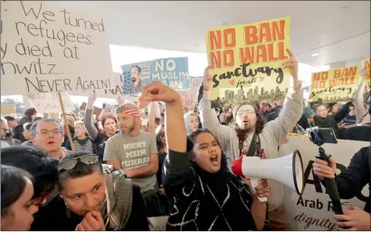  ?? AP ?? Protesters gather at San Francisco Internatio­nal Airport to denounce President Trump’s executive order barring citizens of seven Muslim nations from entering the US in San Francisco. —