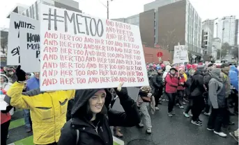  ?? TED S. WARREN/AP ?? A marcher carries a sign with the popular Twitter hashtag #MeToo as she takes part in a Women's March in Seattle on Jan. 20.