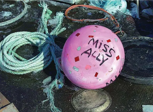  ?? ANDREW VAUGHAN/THE CANADIAN PRESS ?? A buoy from the ill-fated fishing boat Miss Ally rests on the dock in Woods Harbour, N.S. The vessel capsized and sank off the coast, and five fishermen were lost to the sea.