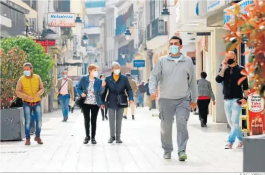  ?? ALBERTO DOMÍNGUEZ ?? Varios onubenses pasean por una de las calles comerciale­s de la capital.