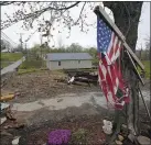  ?? MARK HUMPHREY
THE ASSOCIATED
PRESS ?? A flag hangs last week near the remains of a home destroyed in a Dec. 10 tornado in Dawson Springs, Tenn.