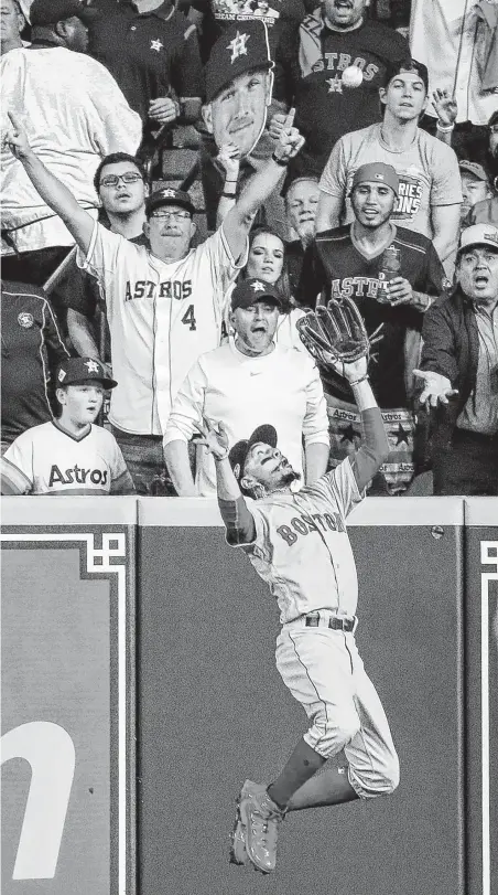  ?? Brett Coomer / Staff photograph­er ?? Astros fans watch as Red Sox right fielder Mookie Betts makes another spectacula­r play, robbing the Astros’ Alex Bregman in the sixth inning of Game 5. Bregman was 0-for-4 for the game batting in the leadoff spot.