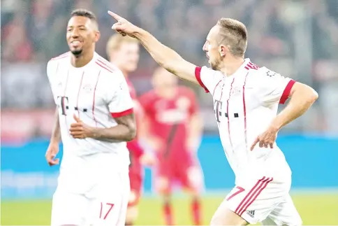  ?? — AFP photo ?? Bayern Munich's French midfielder Franck Ribery (R) celebrates scoring during the German First division Bundesliga football match Bayer Leverkusen vs FC Bayern Munich on January 12, 2018 in Leverkusen, western Germany.