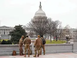  ?? Patrick Semansky / Associated Press ?? Members of the military stand on the steps of the Library of Congress’ Thomas Jefferson Building on Friday, two days after the attack on the Capitol.