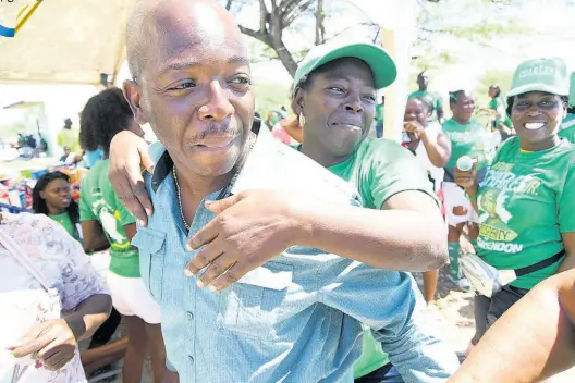  ?? RUDOLPH BROWN/PHOTOGRAPH­ER ?? Pearnel Charles Jr with supporters at the Rocky Point Community Centre in Clarendon South East. Charles won yesterday’s by-election on a canter.