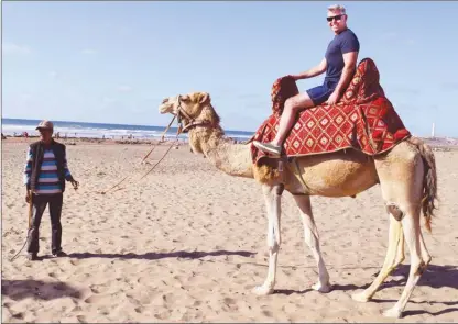  ?? KERRY MacNAULL/Special to The Daily Courier ?? Reporter Steve MacNaull takes camel Rgrariya out for a spin on Lalla Meriem Beach in Casablanca.