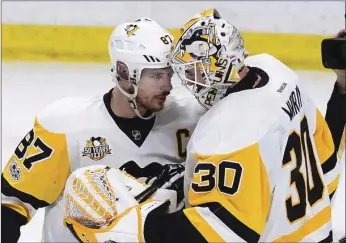  ?? AP PHOTO ?? Pittsburgh Penguins center Sidney Crosby (left) celebrates with goalie Matt Murray after the Penguins' 3-2 win over the Ottawa Senators during their game Friday in Ottawa, Ontario.