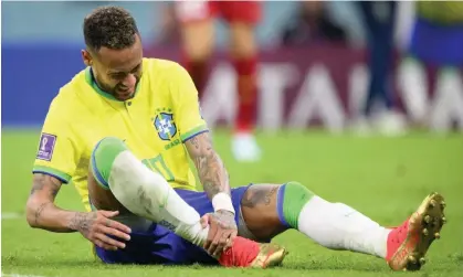  ?? ?? Brazil's Neymar holds his right ankle before being substitute­d during the match with Serbia. Photograph: Laurent Gilliéron/EPA