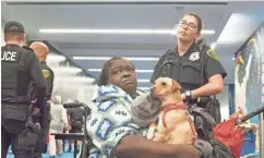  ?? NICK OZA/THE REPUBLIC ?? Mary Williams waits with her dog Mollie after they were evacuated from a shelter in downtown Houston. Rescues continue in Texas, along with the rain.