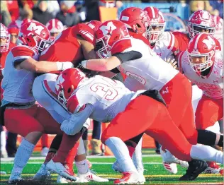  ?? GARY MIDDENDORF/DAILY SOUTHTOWN ?? Members of Marist’s defense wrap up Homewood-Flossmoor’s Leon Tanna during Saturday’s game.