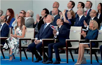 ?? Reuters ?? French President Emmanuel Macron, his wife Brigitte Macron, US President Donald Trump and first lady Melania Trump attend the traditiona­l Bastille Day military parade on the Champs-Elysees in Paris on Friday. —